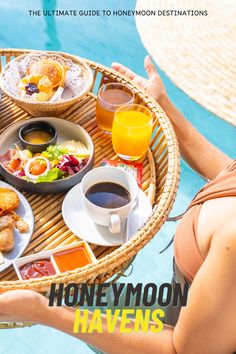 a woman holding a tray with food and drinks on it next to a swimming pool