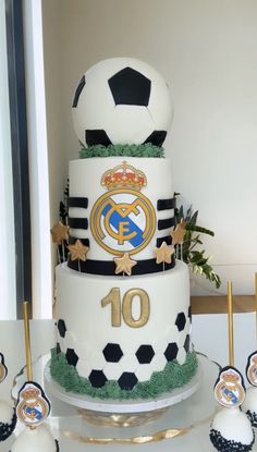 there is a cake with soccer balls and stars on the bottom tier, along with other decorations