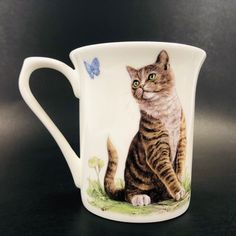 a coffee cup with a cat painted on it