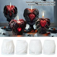 three candles in the shape of hearts on a table