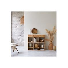 an empty room with white walls and wooden furniture, including a shelf filled with vases