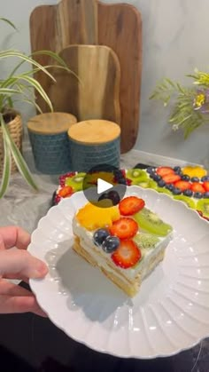 a person holding a plate with a piece of cake on top of it next to other plates