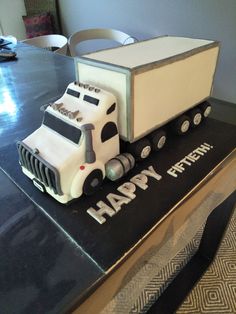 a birthday cake shaped like a truck on top of a table