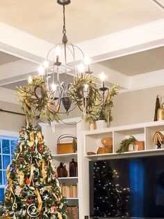 a living room with a christmas tree in the corner and a tv on top of it