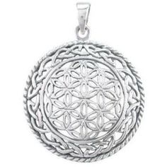 a silver pendant with an intricate design on it