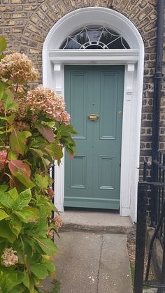 a blue front door on a brick building