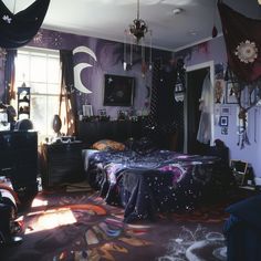 a bedroom decorated in purple and black with lots of decorations on the walls, bedding and curtains