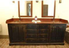 a bathroom with two sinks and mirrors on the wall