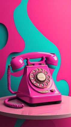 an old pink phone sitting on top of a table next to a blue and pink wall