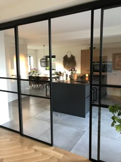 an open kitchen and dining room with sliding glass doors