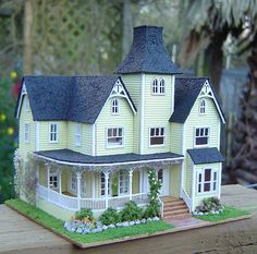 a doll house sitting on top of a wooden table