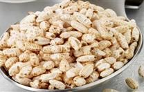 a bowl filled with peanuts sitting on top of a counter