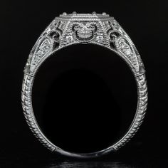 an antique style diamond engagement ring with filigrees