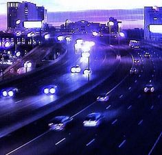 traffic is backed up on the freeway at night in this time lapse photo from an overpass