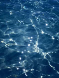 the water is very clear and blue with little bubbles on it's surface,