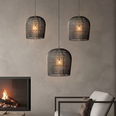 three lights hanging from the ceiling above a fireplace