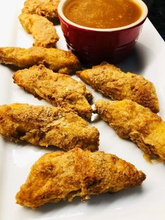 fried chicken sticks and dipping sauce on a white plate