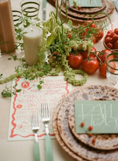 the table is set with plates and place settings