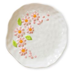 a white plate with pink and yellow flowers on it