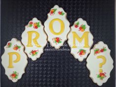 decorated cookies in the shape of letters and flowers