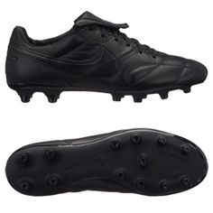 a pair of black soccer shoes on a white background