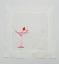 an embroidered cocktail glass on a white napkin