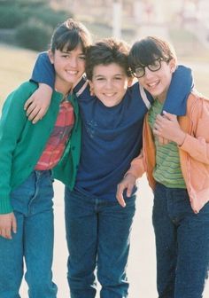 three young boys standing next to each other