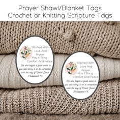 two labels for prayer shawl / blanket tags on top of knitted sweaters