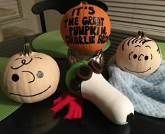 three pumpkins that have been painted to look like charlie brown