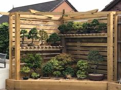 a wooden fence with potted plants on it