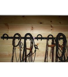 there are many different types of horse tacks hanging on the wall