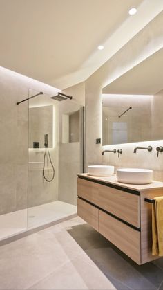 a bathroom with two sinks and a shower