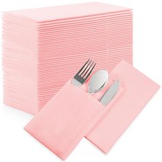 a stack of pink napkins next to a fork and knife on top of each other