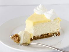 a piece of cheesecake on a white plate with a fork