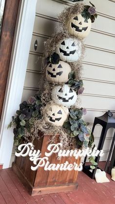 pumpkins are stacked on top of a wooden crate with greenery around it and the words diy pumpkin planters above them