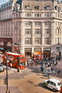 a busy city street filled with lots of traffic and people on the side of it