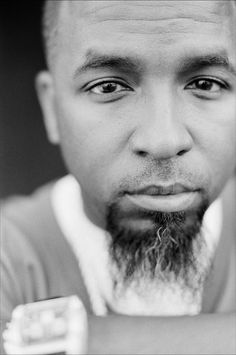 a black and white photo of a man with a beard