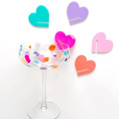 a martini glass with confetti hearts on it