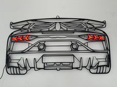 the rear end of a sports car with red arrows on it's tail lights