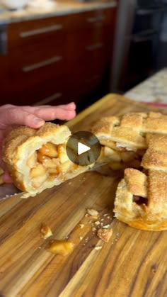 a person is cutting up some food on a wooden board