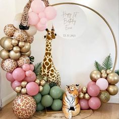 a giraffe surrounded by balloons and other decorations