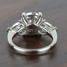 a close up view of a diamond ring on a table