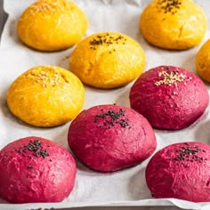 red and yellow baked pastries on a baking sheet with sprinkles in them