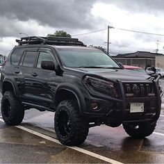 a large black truck parked in a parking lot