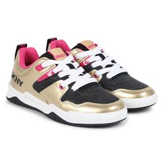 Gold and black trainers for girls by DKNY. Made from soft leather and canvas, they feature the brands logo print in black on the sides and a logo print on the heels. Fasten with white laces and have faux leather inner soles and non slip rubber outer soles. Comes with branded box.  #dknykids #girlssneakers #goldtrainers #fashionfootwear Gold Trainers, Brands Logo, Leather And Canvas, Black Trainers, Girls Sneakers, Black Logo