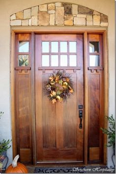 a wooden door with a wreath on it