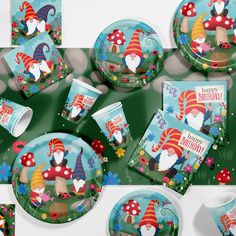 an assortment of party supplies including plates, napkins and cups with gnome designs on them