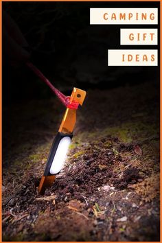 an orange and black flashlight is in the dirt with text reading camping gift ideas on it