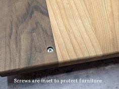 a close up of a wooden table with screws on the top and bottom part