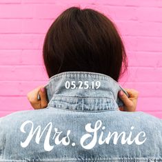 the back of a woman's jean jacket that says mrs slimie